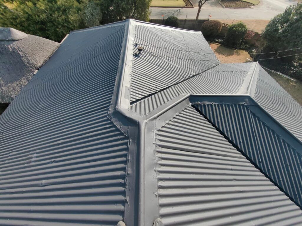 Corrugated house roof finished in a grey coating