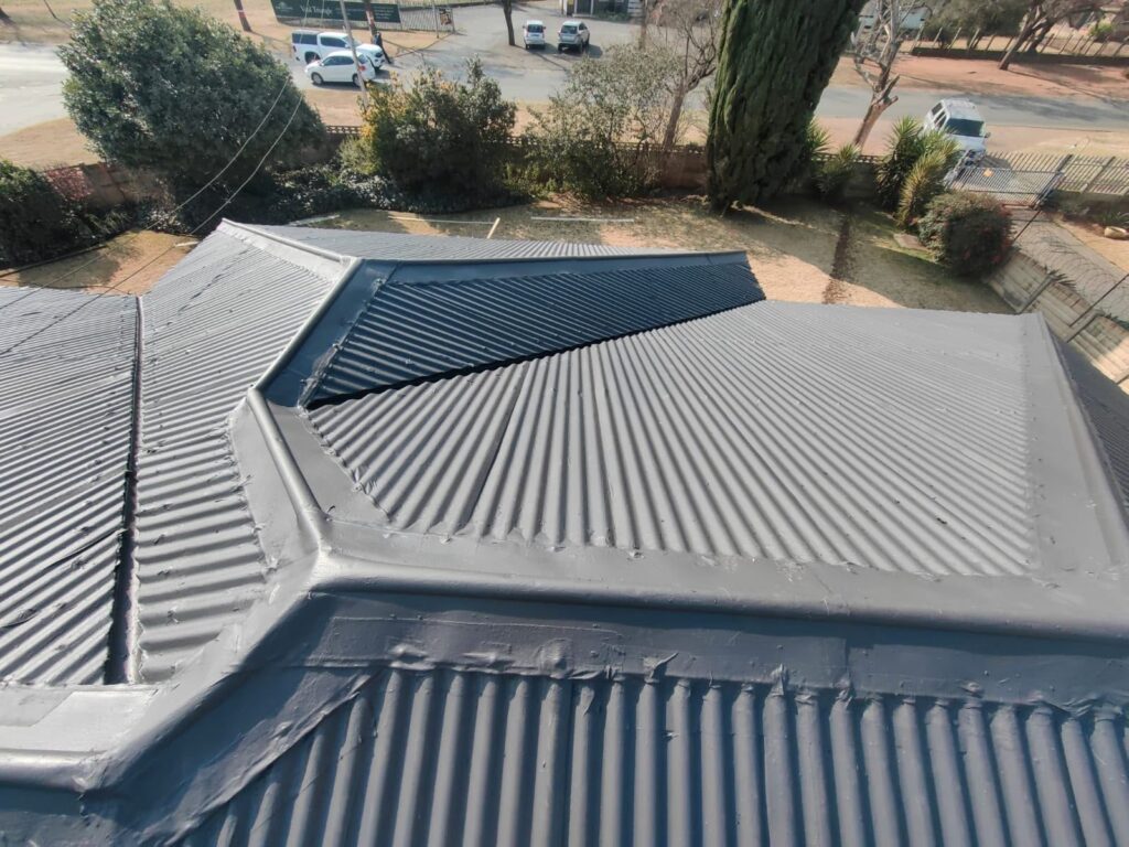 Grey coated corrugated roof with hips and valleys