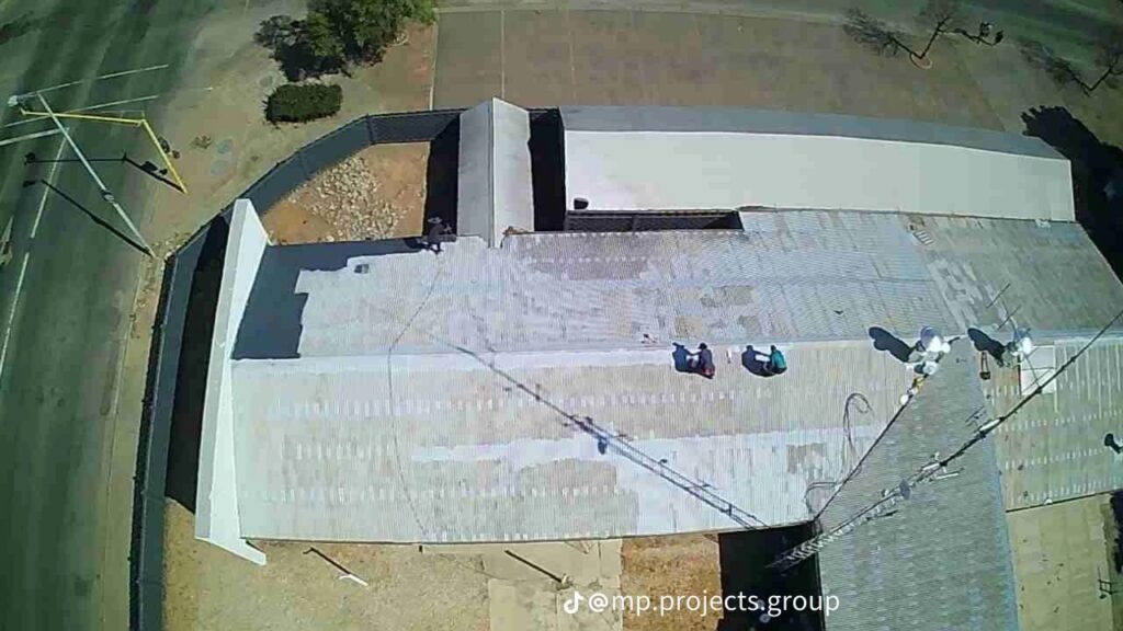 Commercial roof before waterproofing, with faded and weathered sheeting