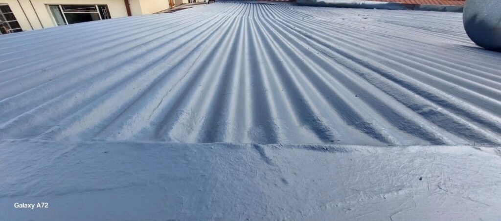 Waterproofing coating on corrugated roof sheeting, close-up