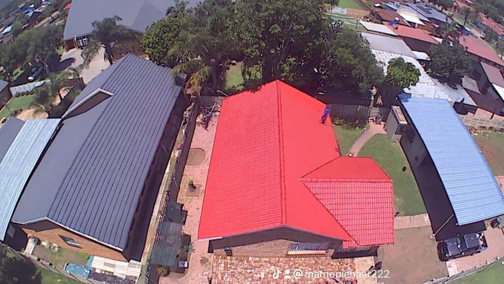 Aerial view of a red coated tile roof between neighbouring houses